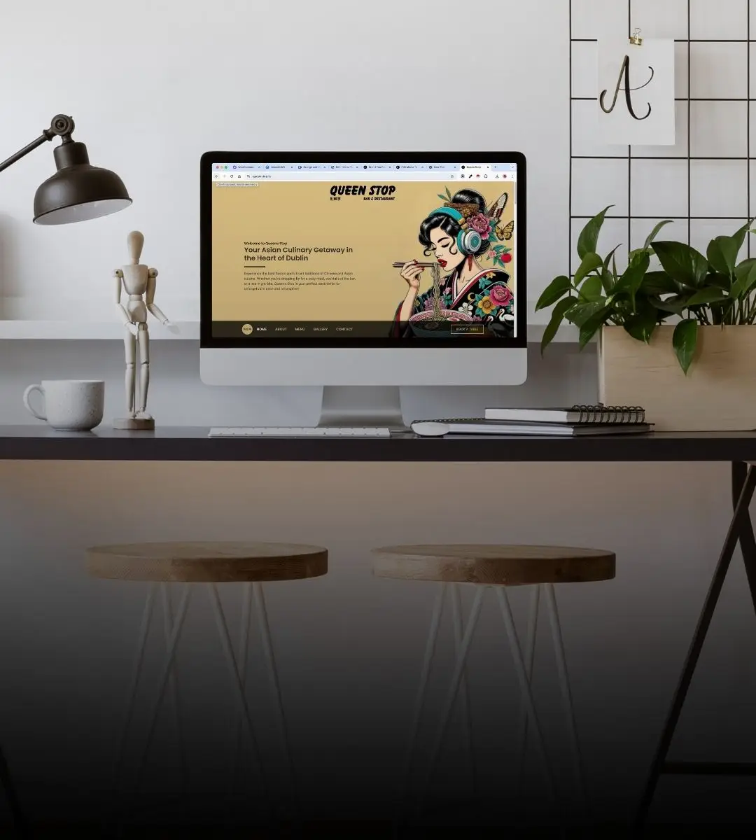 Desktop computer on a studio desk showing a website designed by Brand You