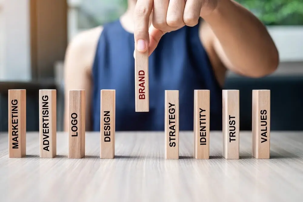 businesswoman-hand-placing-wooden-dominoes-with-te-2022-11-07-22-00-26-utc (1) - Brand You Creative businesswoman-hand-placing-wooden-dominoes-with-te-2022-11-07-22-00-26-utc-1